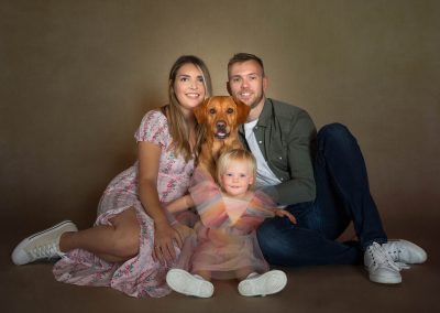 Mum and dad with golden lab dog and smiling baby girl Wirral Family photographer
