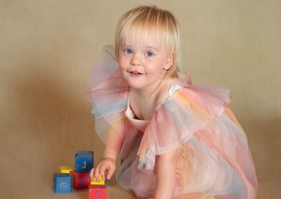 Pretty smiling girl playing with building blocks Wirral family photographer