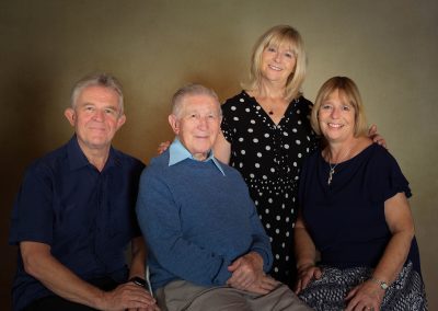 A father celebrating important birthday surrounded by his family Wirral family photographer