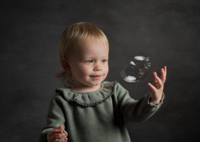 Child playing with a bubble family photographer north wales