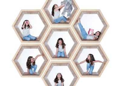 Young girl in 7 hex shaped structures looking around and smiling