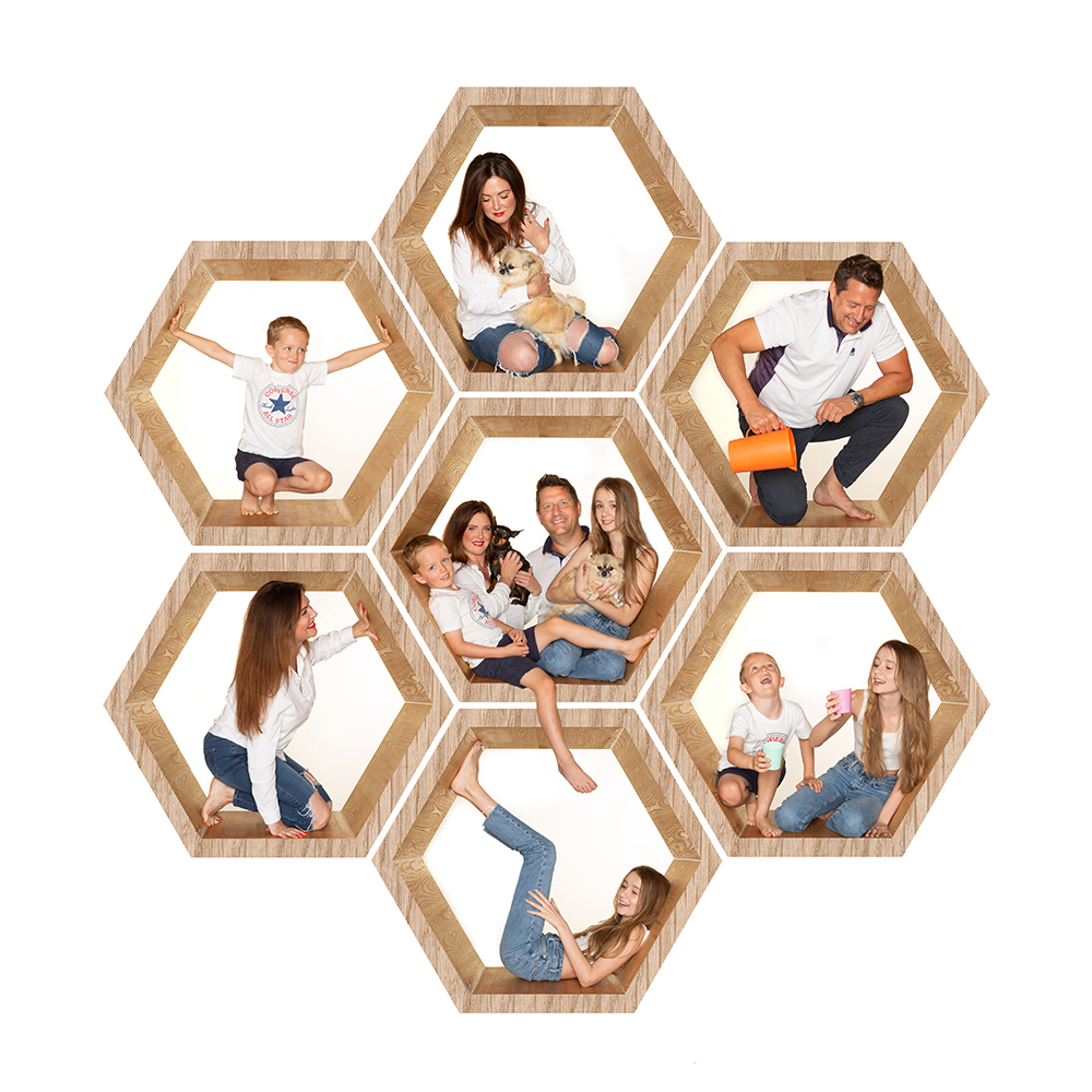 mum,dad and kids sitting in a hex shaped structure together with their dog all smiling